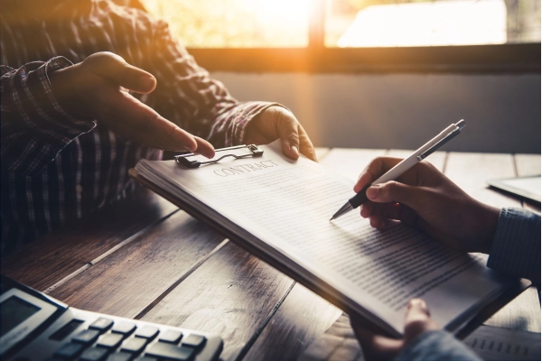 persona firmando un contrato
